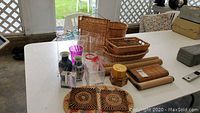 Overview of all items on table including baskets, vases, placemats, and containers