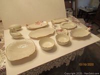 Multiple Lenox china pieces including various serving bowls and condiment dishes arranged on a table