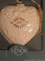 Close-up photo of 1991 heart-shaped Lenox holiday ornament showing embossed design and gold leaf details