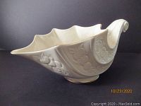 Side angle of Lenox Fruits of Life Cornucopia dish showing embossed fruit and flowers with gold trim