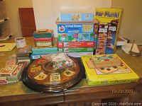 Group photo showing variety of games including the poker pool, puzzles, card decks, Jenga, Ker-Plunk, and checkers