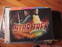 Packaged shirts showing black T-shirt with portraits and Star Trek title