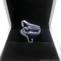 Silver octopus tentacle ring shown from front angle inside black velvet jewelry box.