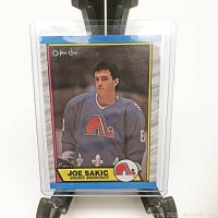 Front view of the 1989 O-Pee-Chee Joe Sakic rookie card in protective plastic sleeve.