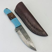 Knife and sheath placed side by side showing entire item and sheath design