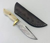 Photo showing the full knife with Damascus steel blade, bone handle, brass guard alongside the leather sheath.