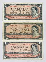 Front side of three 1954 Canadian $2 banknotes showing Queen Elizabeth II portrait and serial numbers.