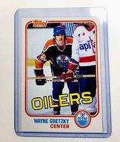 Front of 1981 Topps Wayne Gretzky hockey card in protective sleeve showing player in Edmonton Oilers uniform with stick.