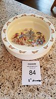 Full view of the Royal Doulton Bunnykins ceramic bowl, showing the inside family Christmas scene and the bowl's shape and size relative to the tag.