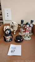 Overview of all items in lot including Toby mug, mug lid, porcelain pony, and three band member figurines
