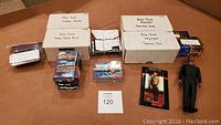 Boxes and stacks of Star Trek trading cards from various series including Master Series and Deep Space Nine with sealed packs and loose cards.