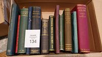 Full box view with 10 hardbound medical books, showing varied colors and titles.