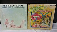 Front covers of two Steely Dan vinyl albums: 'Countdown to Ecstasy' and 'Can't Buy a Thrill'