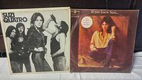 Front covers of two Suzi Quatro vinyl albums: the self-titled album in black and white and the Japanese import 'If You Knew Suzi...' with a color photo.