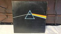 Front of gatefold vinyl LP album cover with iconic pink Floyd prism and rainbow prism light design showing wear on edges.