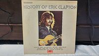 Front cover of the double vinyl album showing Eric Clapton with a guitar and track list.