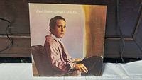 Front cover of vinyl LP 'Paul Simon Greatest Hits Etc.' showing Paul Simon seated in profile.