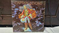 Front album cover of Captain Beyond 1972 debut album showing figure in futuristic costume in space-themed artwork.