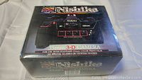 Front of original box showing Nishika branding, model number N8000, quadra lens system illustration and 35mm 3-D label