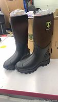 Tall brown and black neoprene rubber boots with TIDEWE logo, displayed upright.