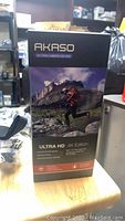 Box of the Akaso EK7000 Action Camera showing model, 4K ultra HD, waterproof case, 170-degree wide angle lens.