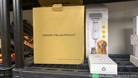 Box of Honey Guardian automatic pet feeder model A36, pet grooming dryer packaging, and pet nail grinder box.