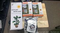 Packaging of LED Plant Grow Light and 2 Crosofmi Watering Timers along with Deyard misting cooling system parts.