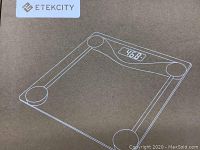 Box showing Etekcity brand and digital scale sketch on front panel with LCD display.