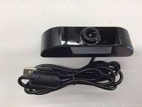 Main webcam USB device showing lens and cable coiled below