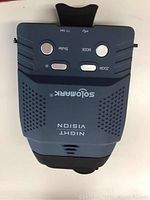 Top view of Digital Solo Mark NV100 night vision goggles showing button controls including shutter, mode, zoom, and IR buttons, USB port, and TF card slot.