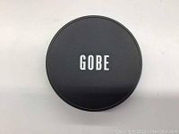 Black circular lens filter case with GOBE logo on cover