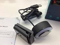 Photo of the Angetube Stream Webcam unit with attached USB cable and user manual on white surface.