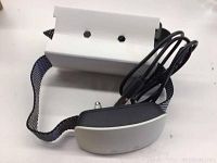 Electronic bark training collar showing front and side views with strap and charging cable