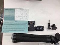 UBeesize tripod legs folded with Bluetooth remote shutter, phone holder, and GoPro style mounts visible