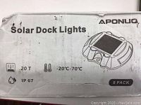 Box showing Aponuo Solar Dock Lights 8-pack, information on 20T weight limit, operating temperature range -20°C to 70°C, and IP67 waterproof rating.