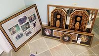 Photo showing three framed items on floor: jungle animal collage, hexagonal relief cameo frame, and mirrored frame with relief designs.