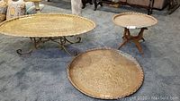 Overview showing oval table on ornate scroll base, round table on wood tripod base, and extra tray on floor
