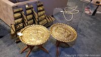 Overview of all items: two brass tables, tall ship art panels and lobster trap on carpet