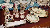 Photo showing Fitz and Floyd plates, serving platter, vase, and Easter-themed ceramic rabbit decorations including rabbit planters and a ceramic dish.