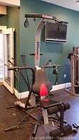 Full front view of Bowflex home gym showing frame, padded bench and overhead pulley assembly