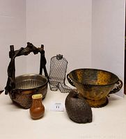 Group photo showing all items: twisted wood basket, cast iron quail, small vase, wire boot, and metal fruit bowl.