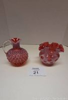 Both items displayed side-by-side, showing the pitcher on the left and ruffled vase on the right.