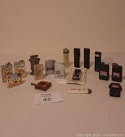Full lot overview of all cigarette lighters and ashtray arranged on table