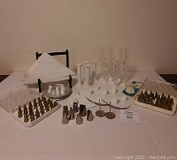 Wide view of entire collection of cake decorating tools arranged on table.