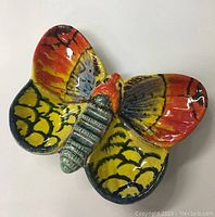 Full top view of butterfly shaped ceramic dish showing vibrant colors and wing details.
