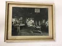 Full view of framed vintage photograph showing interior wood workshop with men working and wooden parts.