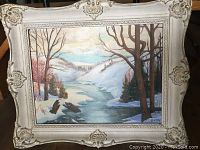 Full view of the painting and ornate frame depicting a snow-covered river landscape.