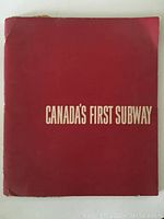 Image of the front cover of the brochure, red background with white text reading "Canada's First Subway." Shows wear at edges and corners.