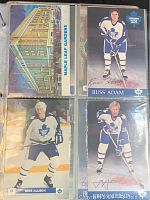 Four vintage Toronto Maple Leafs postcards in binder plastic sleeves including images of Russ Adam, Mike Allison, John Anderson, and a Maple Leaf Gardens landmark card.