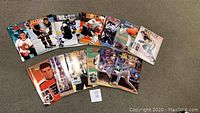 Photo showing 14 assorted Beckett magazines laid out on a carpet. Covers feature various sports figures, primarily hockey and baseball, some football.